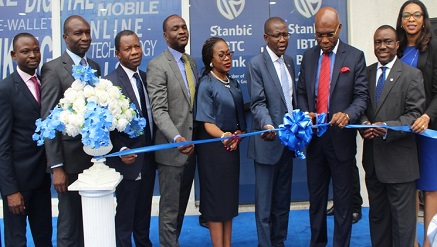 Chairman, Zinox Group, Leo Stan Ekeh (third from right) and Chief Executive Officer, Stanbic IBTC Bank, Yinka Sanni (fourth from right) perform the official cutting of the tape in the presence of other Senior Executives of Stanbic IBTC Bank at the launch of the bank's digital branch located at the Maryland Mall, along Ikorodu Road, Lagos on Wednesday December 14th 2016...